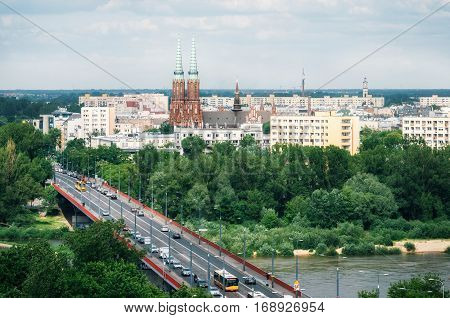 Aerial view of cityscape of Warsaw Slasko-Dabrowski bridge over the the Vistula river on the foreground and Cathedral of St. Michael the Archangel and St. Florian the Martyr among the buildings of Praga district on the background. Poland