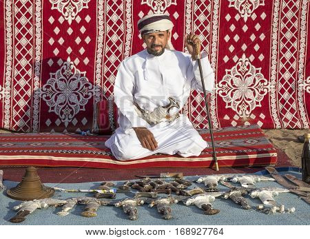 Muscat Oman February 4th 2017: omani man selling traditional khanjar daggers