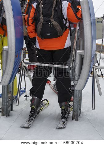 The ski lift Sun Jet at the Horberg mountain in Tyrol Austria with people in the queue for a lift to the mountaintop