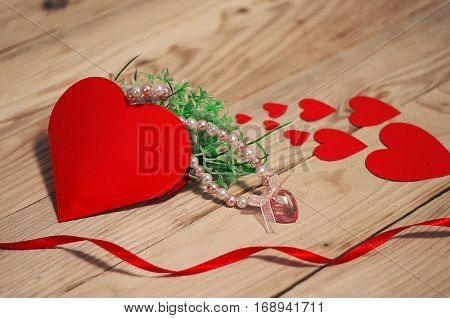 Hearts flowers ribbons on a wooden light background