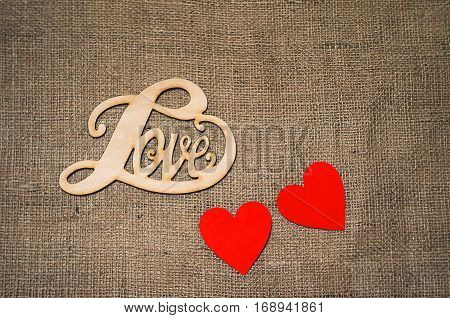 Hearts flowers ribbons on a wooden light background
