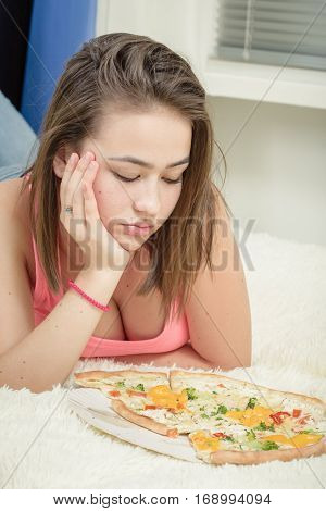 unhappy woman with pieces of pizza on white background
