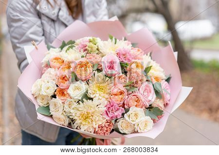 Beautiful Spring Bouquet In Woman Hand. Arrangement With Various Flowers. The Concept Of A Flower Sh