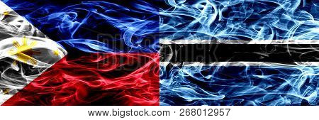 Philippines Vs Botswana, Botswanan Smoke Flags Placed Side By Side. Thick Abstract Colored Silky Smo