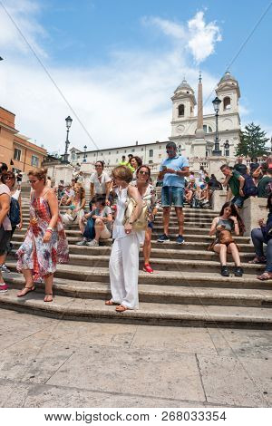 ROME - AUGUST 3: The Spanish Steps, with tourists, seen from Piazza di Spagna on August 3, 2018, Rome.The Spanish Steps are the widest staircase in Europe.