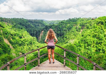 Family Vacation Lifestyle. Young Woman Stand On Edge Of Overhanging Bridge On High Cliff. Happy Girl