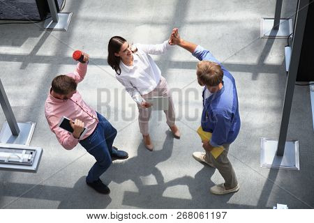 Top View Of Young Modern Colleagues In Smart Casual Wear Working Together While Spending Time In The