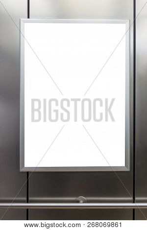 Mock Up. Vertical Poster Media Template Frame Hanging On The Wall In Elevator Lift.