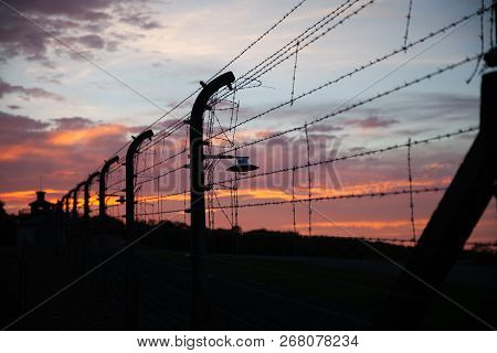 Detail View Of The Antique Barbed Wire Fence  From Buchenwald On Dark Sunset Sky Background Weimar G