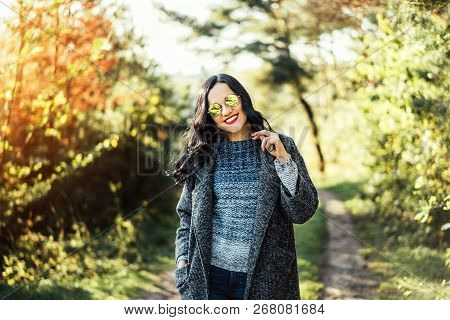 Pretty Long Hair Bruntte Girl Walking In The Autumn Forest.