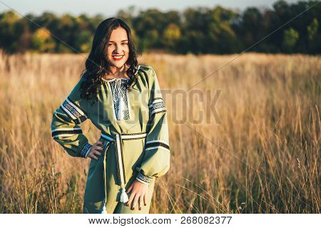 Pretty Young Brunette Girl In Long Embroidery Dress Outdoor