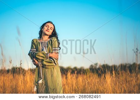 Pretty Young Brunette Girl In Long Embroidery Dress Outdoor