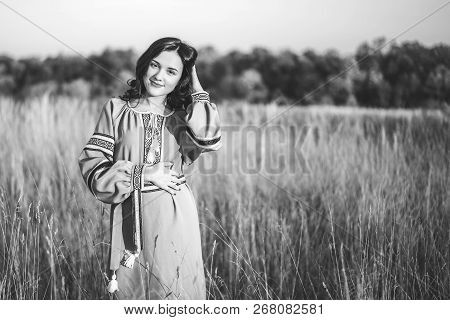 Pretty Young Brunette Girl In Long Embroidery Dress Outdoor