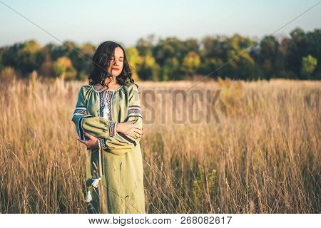 Pretty Young Brunette Girl In Long Embroidery Dress Outdoor