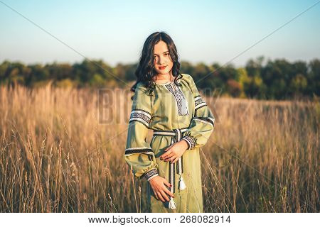 Pretty Young Brunette Girl In Long Embroidery Dress Outdoor