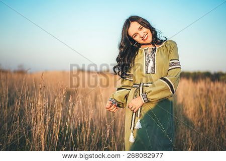 Pretty Young Brunette Girl In Long Embroidery Dress Outdoor