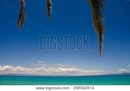 View Of Blue Paradise Water Of Toroneos Kolpos Gulf, Blue Sky And White Clouds Over Sithonia Peninsu