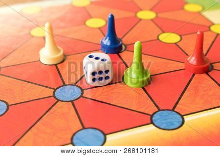 Multi-colored Game Chips With Dice On The Playing Board. Board Game.
