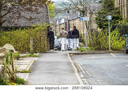 Todmorden , England - May 04 2018 : Refugees Walking In The Centre Of Todmorden Which Meaning Is Dea