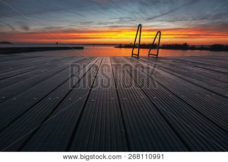 Architecture Outdoor Swimming Pool At The Lake With Metal Aluminum Swimming Stairs During An Impress