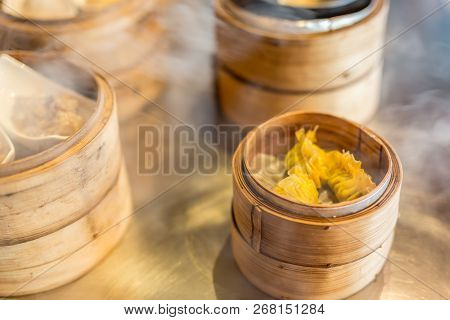Various Chinese Steamed Dumpling In Bamboo Steamer In Chinese Restaurant. Yumcha, Dim Sum