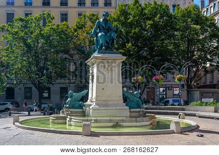 Lyon, France - July 18, 2018: Tourists On Square Ampere With A Statue Made By Charles Textor Portray