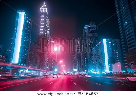 Driving A Car On Sheikh Zayed Rd In Dubai At Night, United Arab Emirates. Blurred Motion. Duotone Re