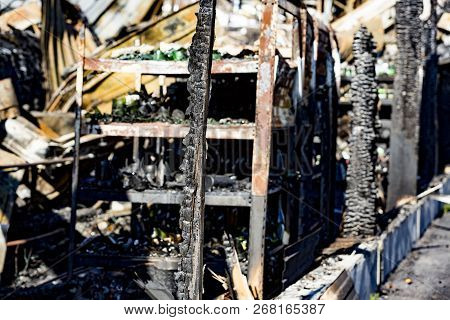 Close Up Damaged Supermarket Glass Plastic Bottles On Shelves After Arson Fire With Burn Black Dark 