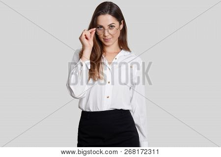 Self Confident Teacher Wears Round Glasses, Formal Clothes, Listens Attentively Answer Of Question, 