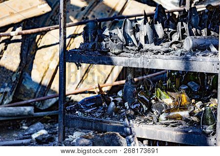 Close Up Damaged Supermarket Glass Plastic Bottles After Arson Fire With Burn Black Dark Debris Afte
