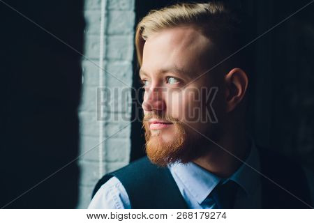 Portrait Of Blonde Young Man With Uncommon Appearance Wears White T Shirt.