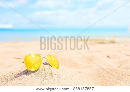 Yellow Sunglasses On The Beach. Resort Concept