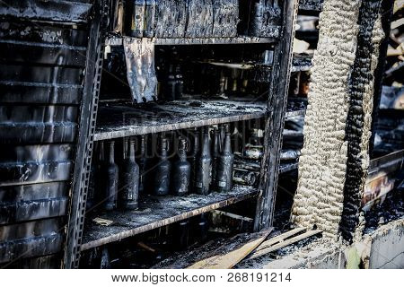 Close Up Damaged Supermarket Glass Plastic Bottles After Arson Fire With Burn Black Dark Debris Afte