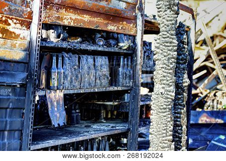 Close Up Damaged Supermarket Glass Plastic Bottles On Shelves After Arson Fire With Burn Black Dark 