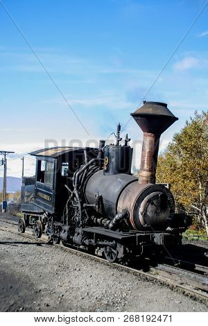 MOUNT WASHINGTON COG RAILWAY, BRETTON WOODS, NH - October 6, 2007:  Mount Washington cog railway locomotive in foliage season with blue sky.