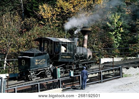 MOUNT WASHINGTON COG RAILWAY, BRETTON WOODS, NH - October 6, 2007:  Mount Washington cog railway locomotive in foliage season with blue sky.