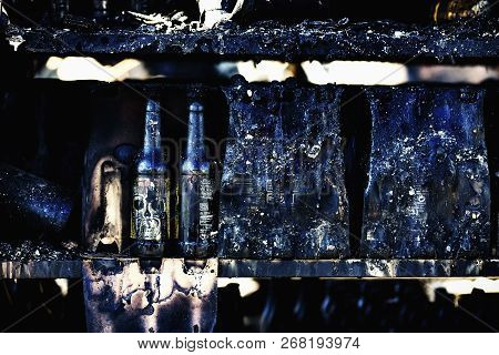 Close Up Damaged Supermarket Glass Plastic Bottles After Arson Fire With Burn Black Dark Debris Afte