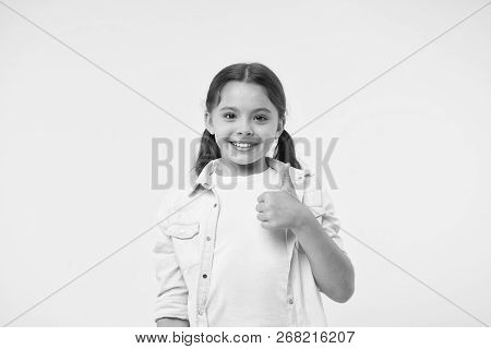 Good Quality. Kid Girl Shows Thumb Up Gesture Recommends Yellow Background. Child Highly Recommend W