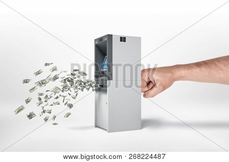 An Atm Being Stricken By A Mans Hand From Behind So That Cash Is Coming Out Of It.