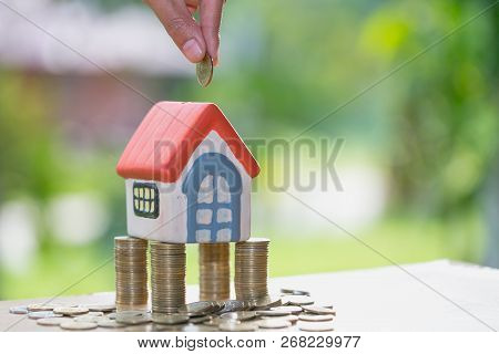 Hand Putting Money Coin Stack With Small House, Purchase Of Habitation, Buy A House, Property Invest