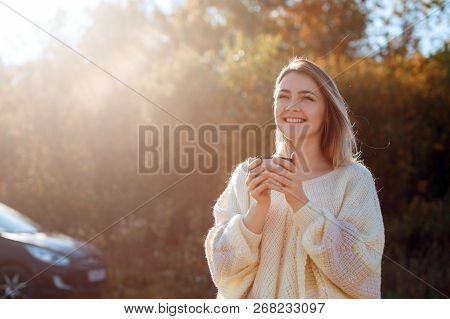 Beautiful Admiring Woman Drinking Hot Tea From Thermos Cup With Backligth Sun.