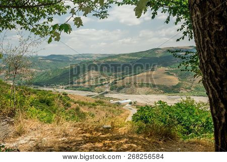 Landscape With Mountain And River With Natural Tree Leaves Border Or Frame. Place For Copyspace.