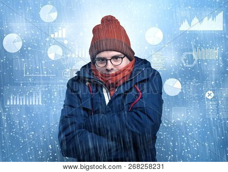 Young businessman shivering with graphs, reports and chart concept