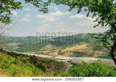 Landscape With Mountain And River With Natural Tree Leaves Border Or Frame. Place For Copyspace.
