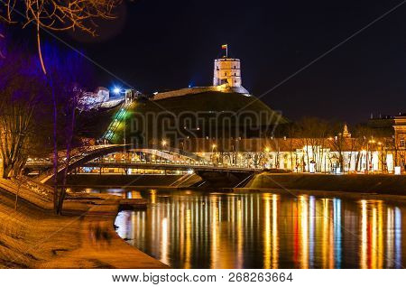 Night Cityscape Of Vilnius. Gediminas' Tower, Neris River, Mindaugas' Bridge