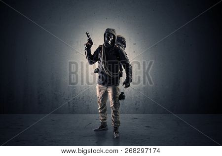 Bad agent in a dark room with arms on his hand and gas mask