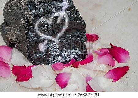 Stone With An Inscription About Love In Rose Petals Background For Design