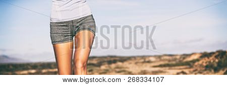 Exercise weigth loss fitness concept runner woman running on trail closeup of hips and legs. Sportswear girl wearing shorts outdoors banner panorama.