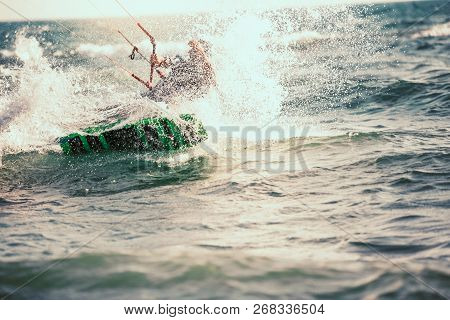 Professional Kiter Makes The Difficult Trick On A Beautiful Background. Kitesurfing Kiteboarding Act