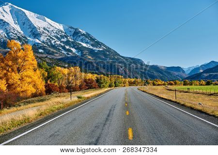 Highway in Colorado Rocky Mountains at autumn, USA. Mount Sopris landscape.
